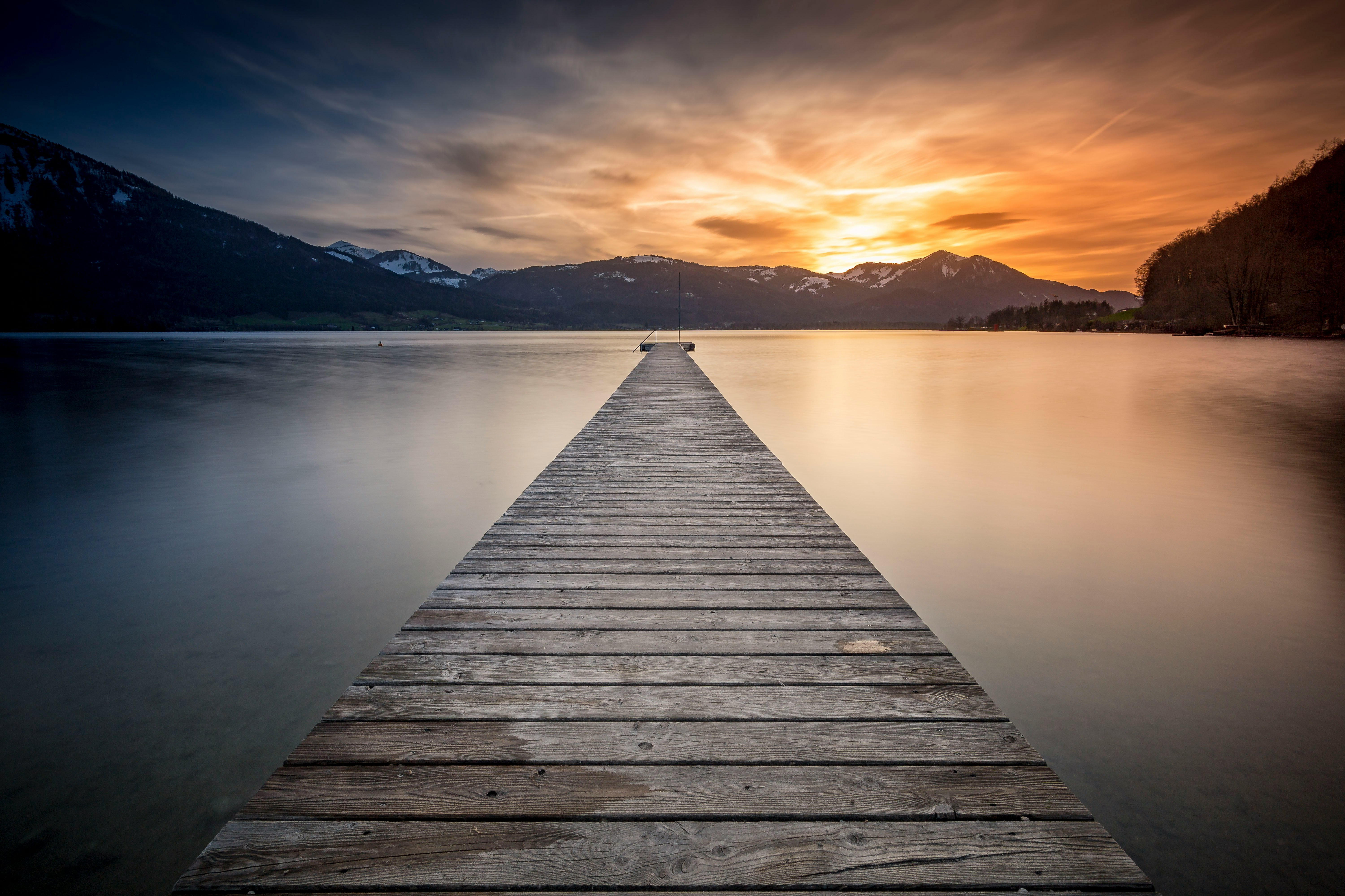 empty gray wooden boardwalk during golden hour